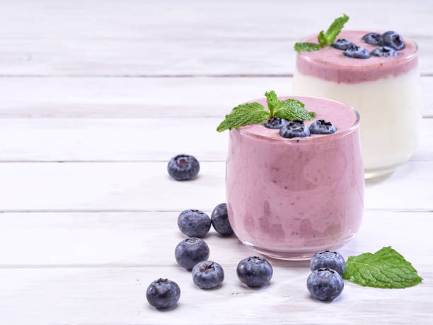 istock Fresh blueberry yogurt and mint leaves placed on a white wooden table. Fruit vitamins for health. 1168601083