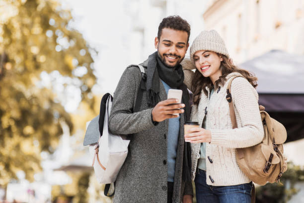 istock Beautiful happy couple using smartphone 1168604037