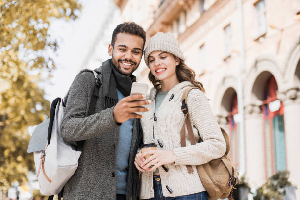 Beautiful happy couple using smartphone