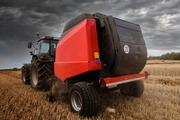 istock tractor and its trailer to press the straw 1168605051
