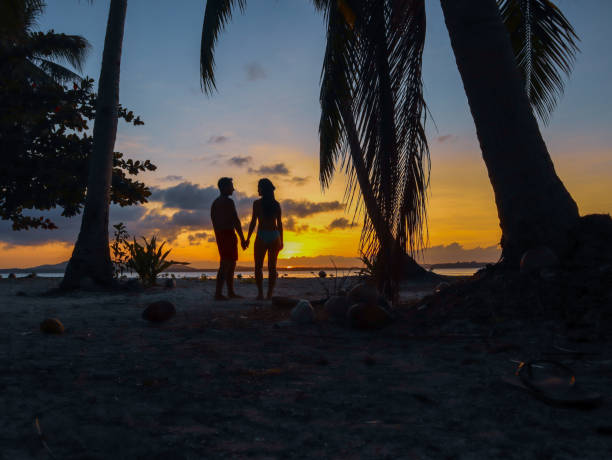 istock Couple watching sunset with palm trees in Palawan 1168605615