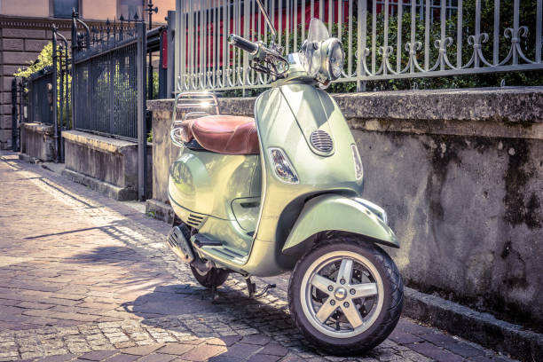 scooter parked on an old street, rome, italy - vespa scooter imagens e fotografias de stock