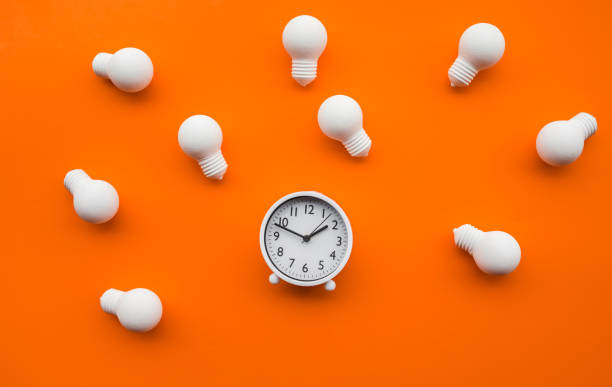 Time,dateline and creativity concepts with group of lightbulb and alarm clock on color background.Business solution.Performance of human