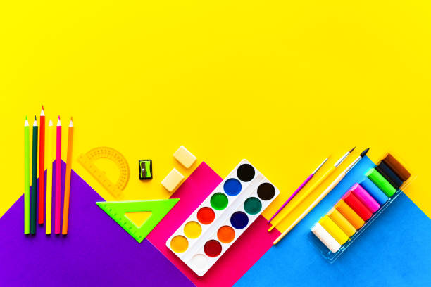 istock School bright supplies on a yellow background. 1168612873