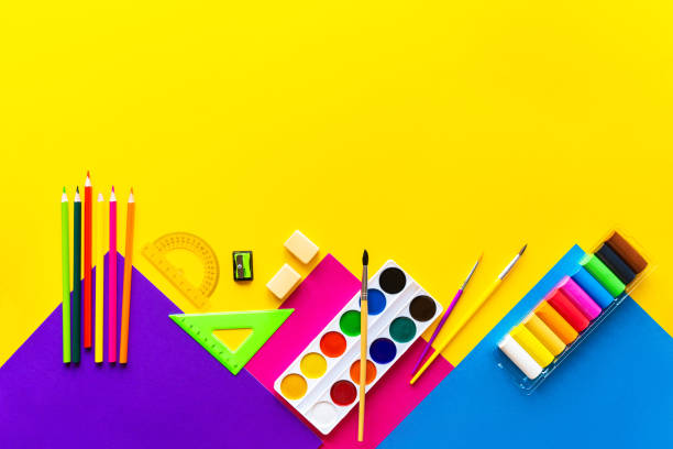 istock School bright supplies on a yellow background. 1168612877