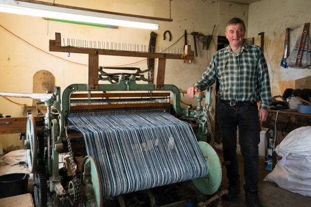 istock Man beside his Hattersley loom used for creating tweed cloth 1168613246