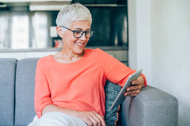 istock Mature woman relaxing with digital tablet 1168614241