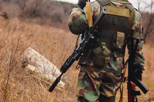 istock Soldier with a weapon, green men 1168614418