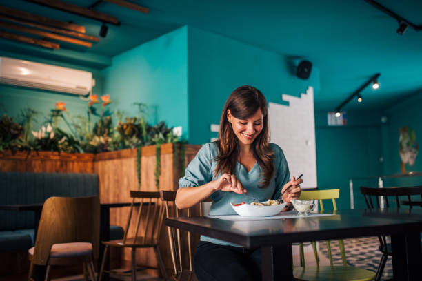 istock Happy woman eating meal at cozy restaurant, portrait. 1168615708