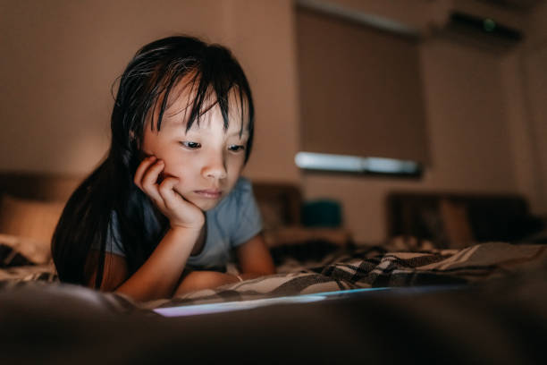 istock Little girl using tablet late at night 1168618713