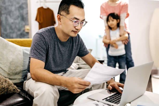 istock Man working at home while wife and daughter playing 1168618721