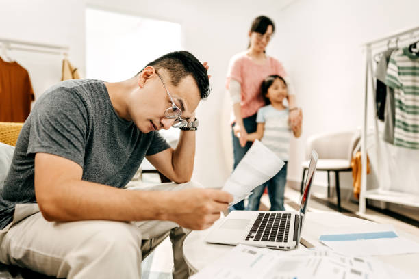 istock Man working at home while wife and daughter playing 1168618799