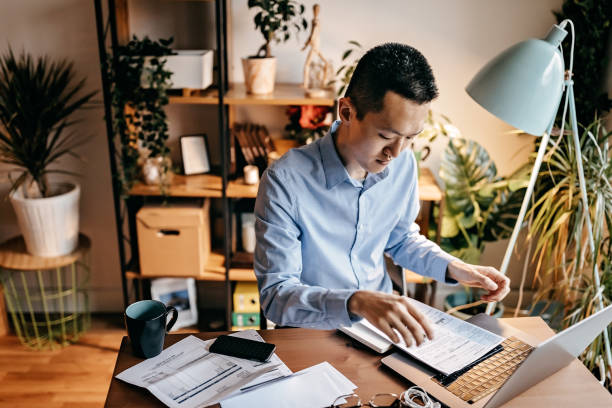 istock Young man calculating his home expenses 1168618850