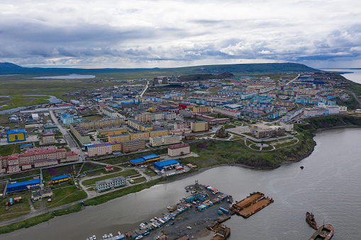 Anadyr, Russia - July 24, 2019: View of residential quarters, coast and boat moorings of the city of Anadyr. Shooting from above drone.
