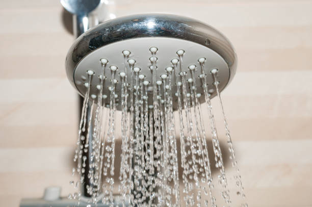 istock Shower head with water flowing 1168620297