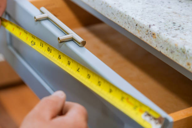 istock Installation of drawers handles on kitchen cabinets 1168622896