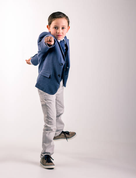 istock Boy in suit pointing fist forward 1168626795