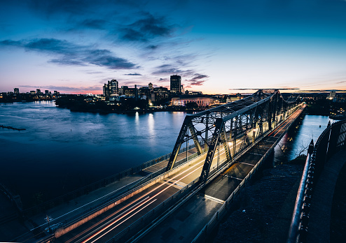 Dusk time Urban landscape of Ottawa River with bridge to Hull. View overlooking Ottawa river, dividing the city on two Provinces (Ontario and Quebec).