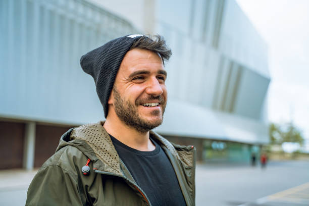 istock Cheerful man with a wool hat at the street 1168631200