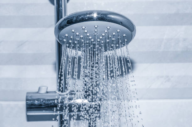 istock Shower head close up with running pure water 1168631471