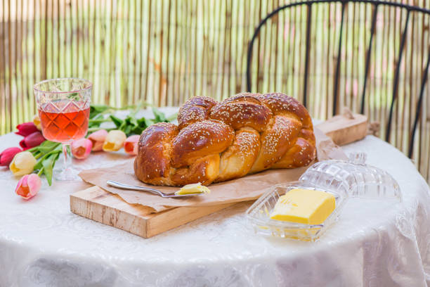 Challah bread on round table served with Amber wine stock photo