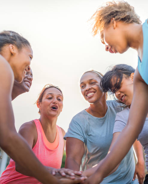 istock Female players stacking hands before soccer match 1168636479