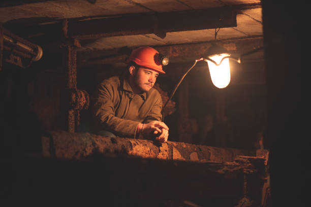 istock A young guy in a protective suit and helmet sits in a tunnel with a burning scrapbook 1168637030