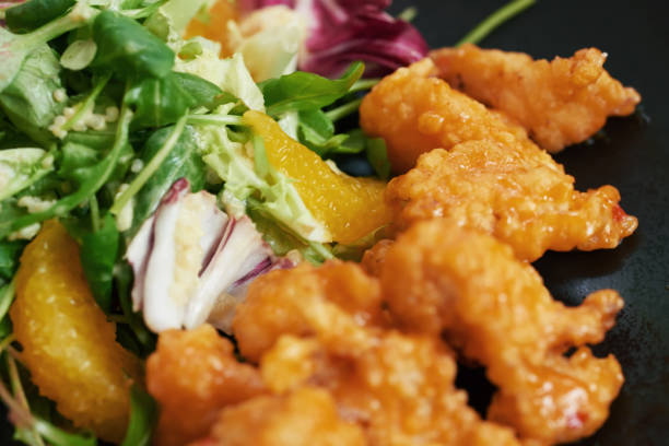 istock Shrimp in batter close-up on a black plate in daylight 1168641079