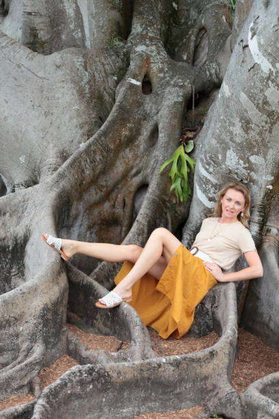 istock Women is sitting on a tree roots 1168642099