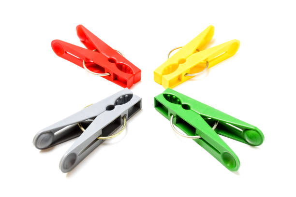 istock Plastic clothespins of different colors close-up on white background 1168642220