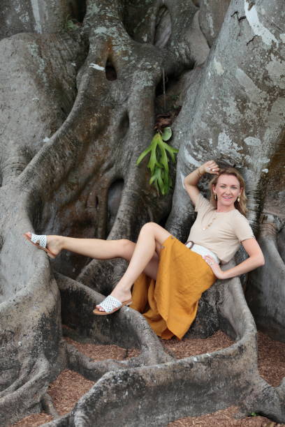 istock Women is sitting on a tree roots 1168642824