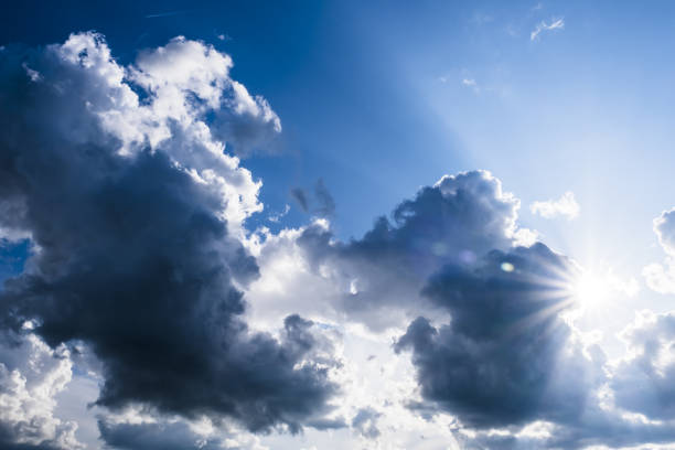 photo of the sun breaking through the storm clouds stock photo