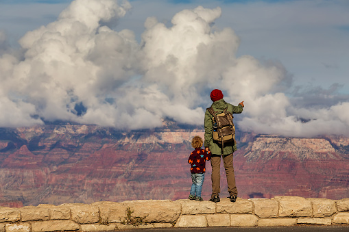 A man with his son are hiking in Grand canyon National Park