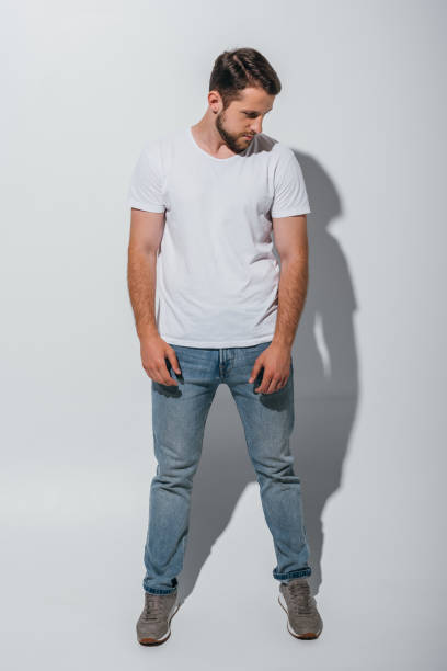 istock full length view of handsome young man standing and looking away 1168651695