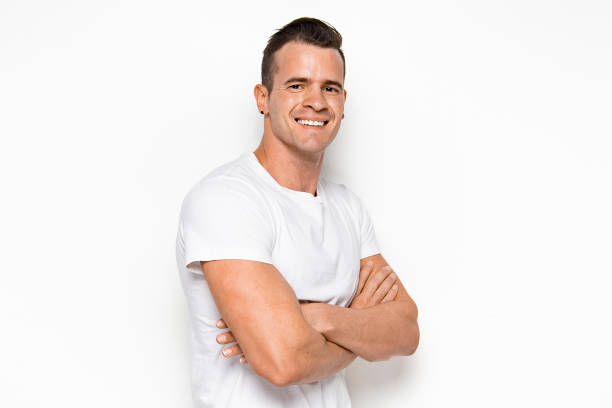 istock Handsome man wearing white shirt with arms crossed 1168657250