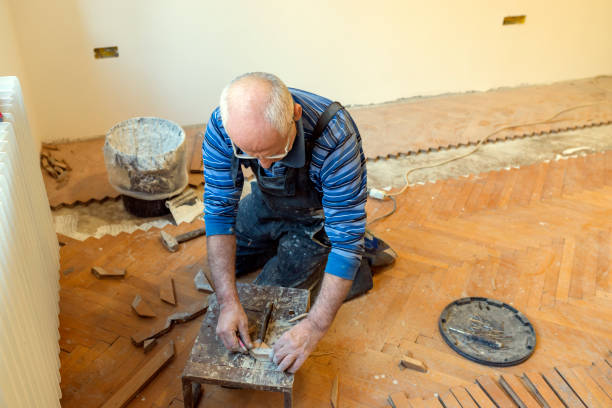 istock Senior Parquet Worker is Cutting the Floor Boards with Chop Saw 1168657398