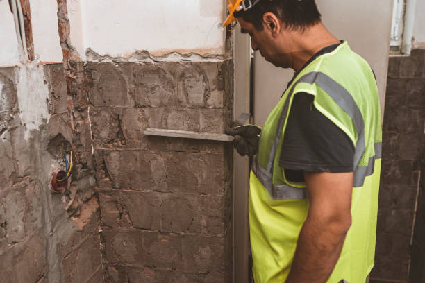 istock Man is Renovating Home and Checking the Level of Wall 1168657440