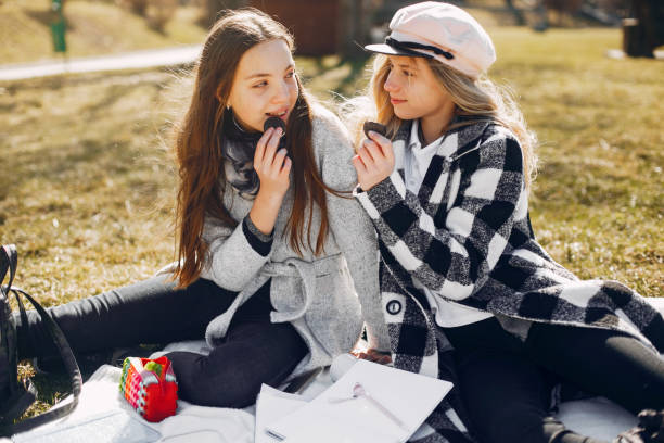 istock Two pretty girls in a summer park 1168658360