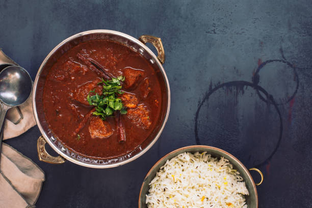 istock Kashmiri Lamb Rogan Josh. Slow cooked lamb curry served with pulao rice and garnished with coriander 1168659065