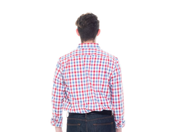 istock Attractive young man wearing a checked shirt and jeans - hands by side 1168660086