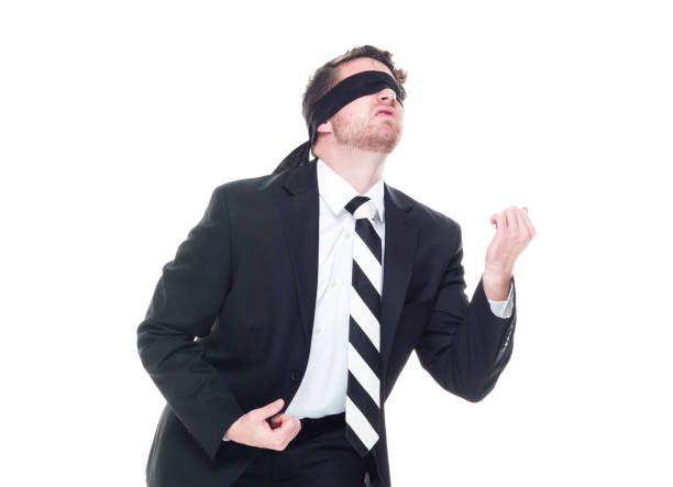 istock Handsome businessman wearing a black suit - is wearing a blindfold 1168660108