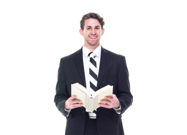 istock Good looking young businessman wearing black suit - holding book 1168660125