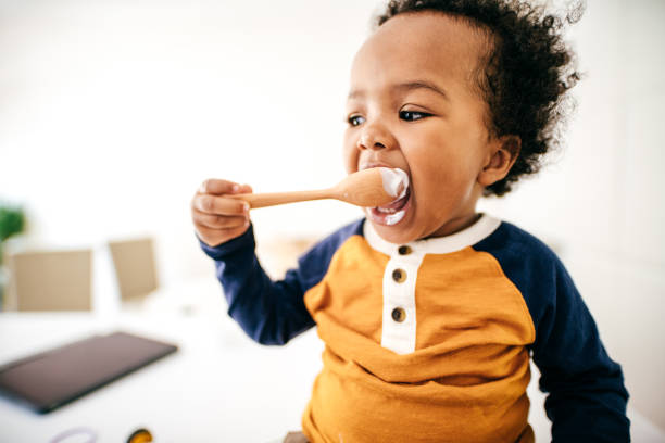istock Toddler eating yogurt 1168661482