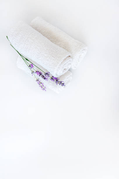 istock white clean towels and lavender flowers on white isolated background 1168662362