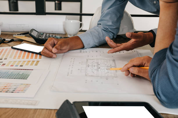 istock architect interior designer working with house drawing plan & color swatch 1168662528