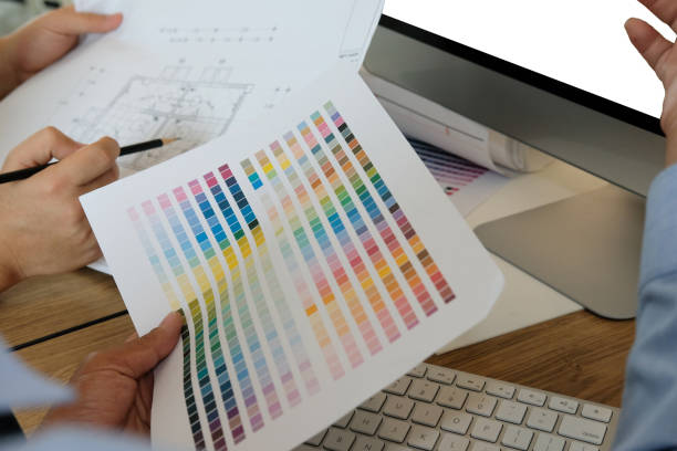 istock architect interior designer working with house drawing plan & color swatch 1168662555