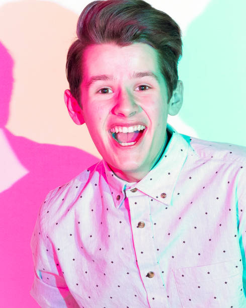 istock Handsome young man standing against white wall with colorful shadows 1168664314