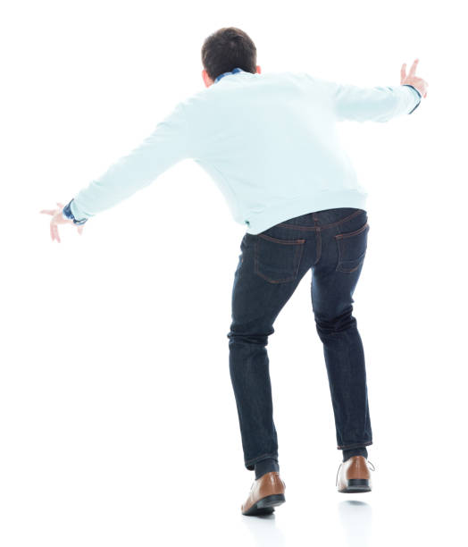 istock Handsome young man walking carefully. Rear view. 1168665639