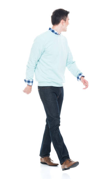 istock Handsome young man walking and looking behind 1168665658