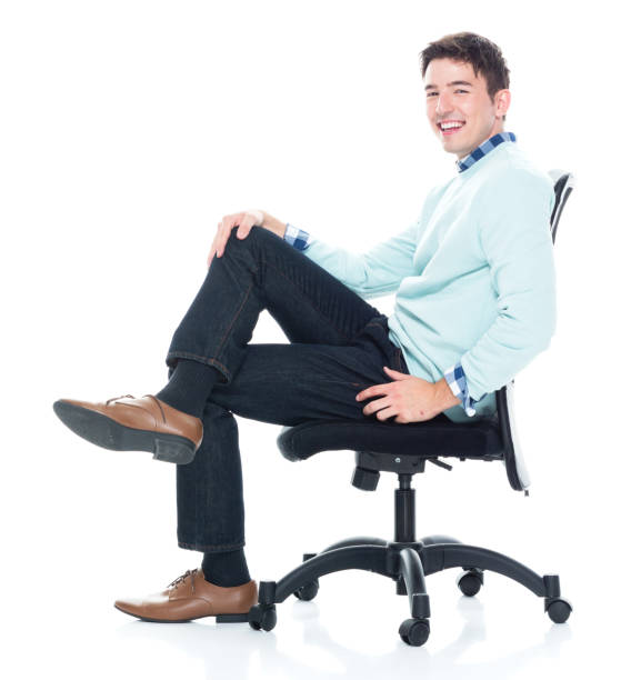 istock Handsome young man sitting and and being happy, side view 1168665679